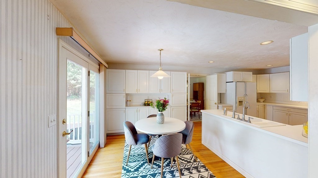 90 Cranberry Circle Sudbury, MA 01776 - Photo 11 of 37 a dining room with furniture a chandelier and wooden floor