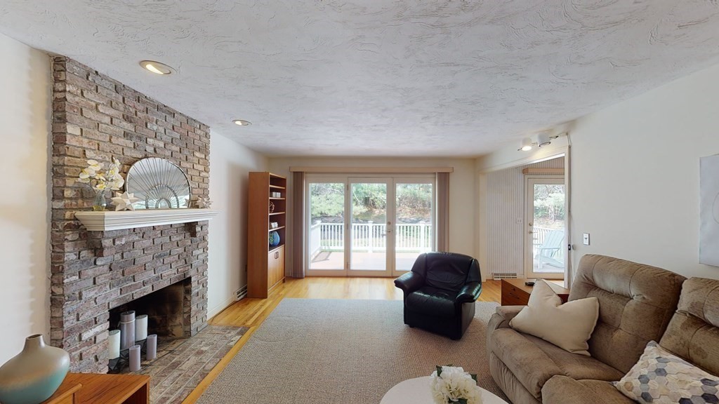90 Cranberry Circle Sudbury, MA 01776 - Photo 16 of 37 a living room with furniture a fireplace and a large window