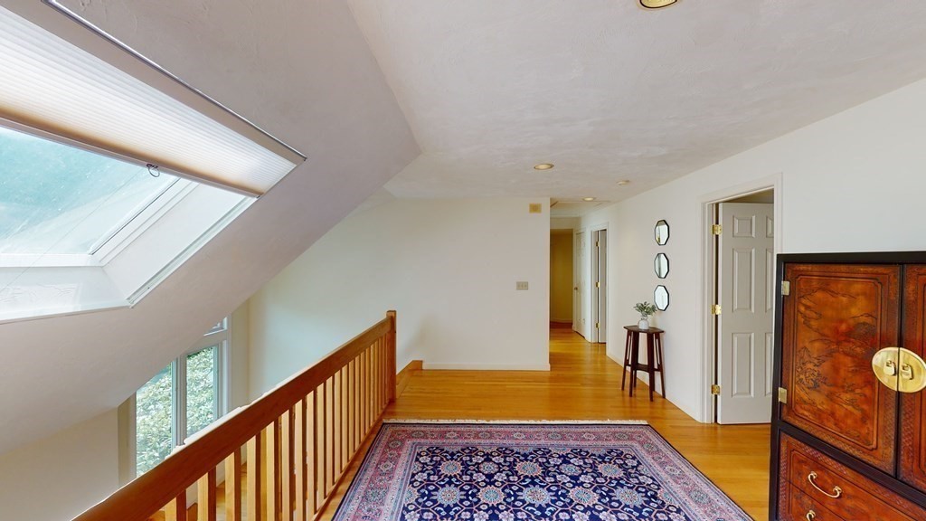 90 Cranberry Circle Sudbury, MA 01776 - Photo 17 of 37 a view of hallway with wooden floor and a rug