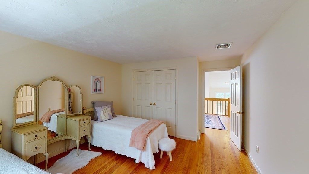 90 Cranberry Circle Sudbury, MA 01776 - Photo 24 of 37 a bedroom with a bed and wooden floor