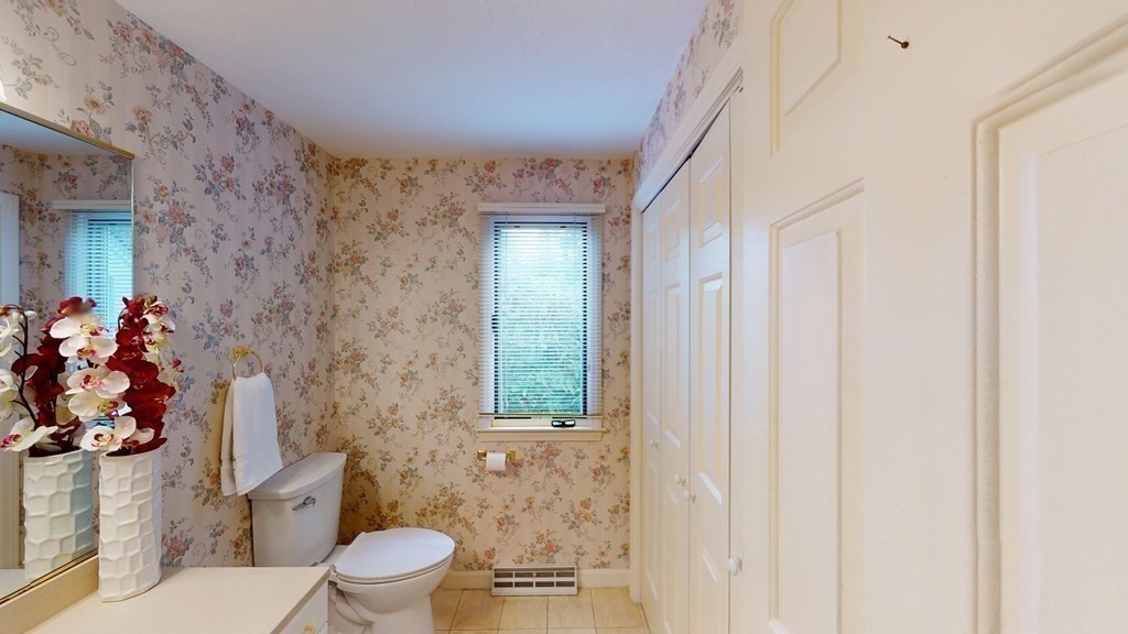 90 Cranberry Circle Sudbury, MA 01776 - Photo 30 of 37 a bathroom with a toilet sink and mirror