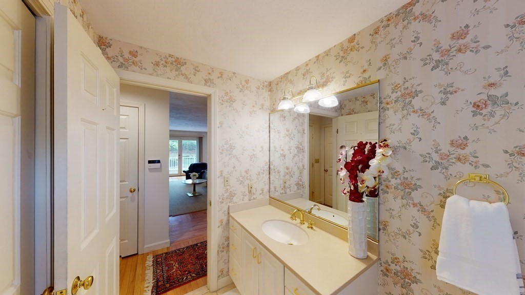 90 Cranberry Circle Sudbury, MA 01776 - Photo 31 of 37 a bathroom with a sink mirror and shower