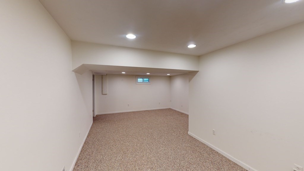 90 Cranberry Circle Sudbury, MA 01776 - Photo 34 of 37 an empty room with a empty space and windows