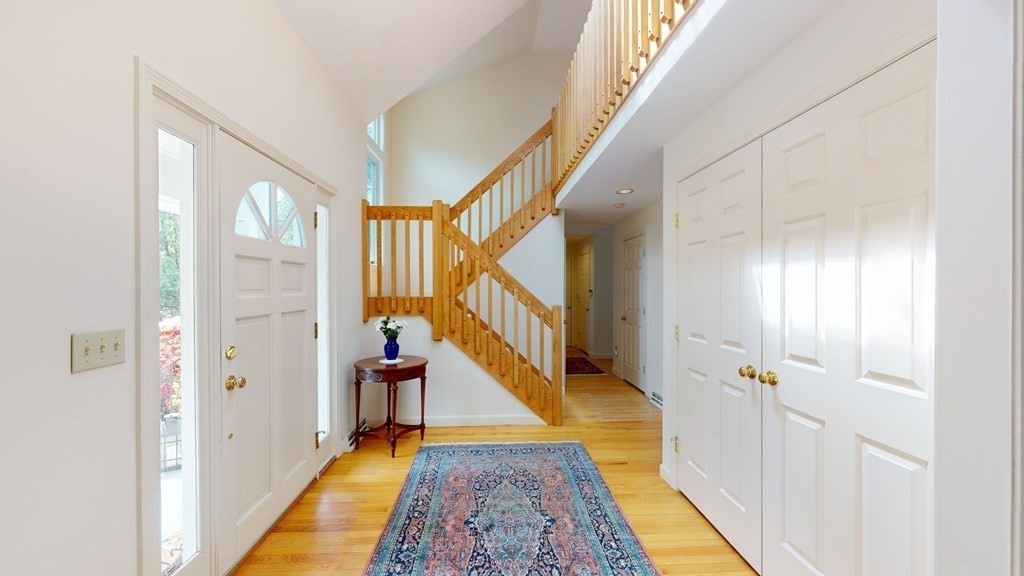 90 Cranberry Circle Sudbury, MA 01776 - Photo 5 of 37 a view of a hallway with wooden floor and staircase