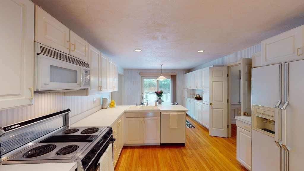 90 Cranberry Circle Sudbury, MA 01776 - Photo 9 of 37 a kitchen with a refrigerator and a stove top oven