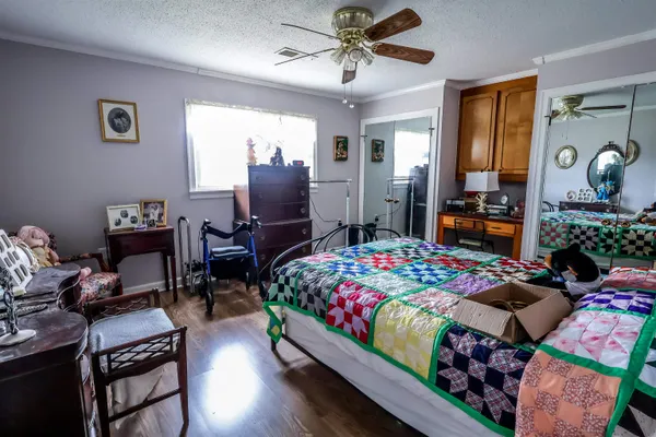 a bedroom with bed and a chandelier