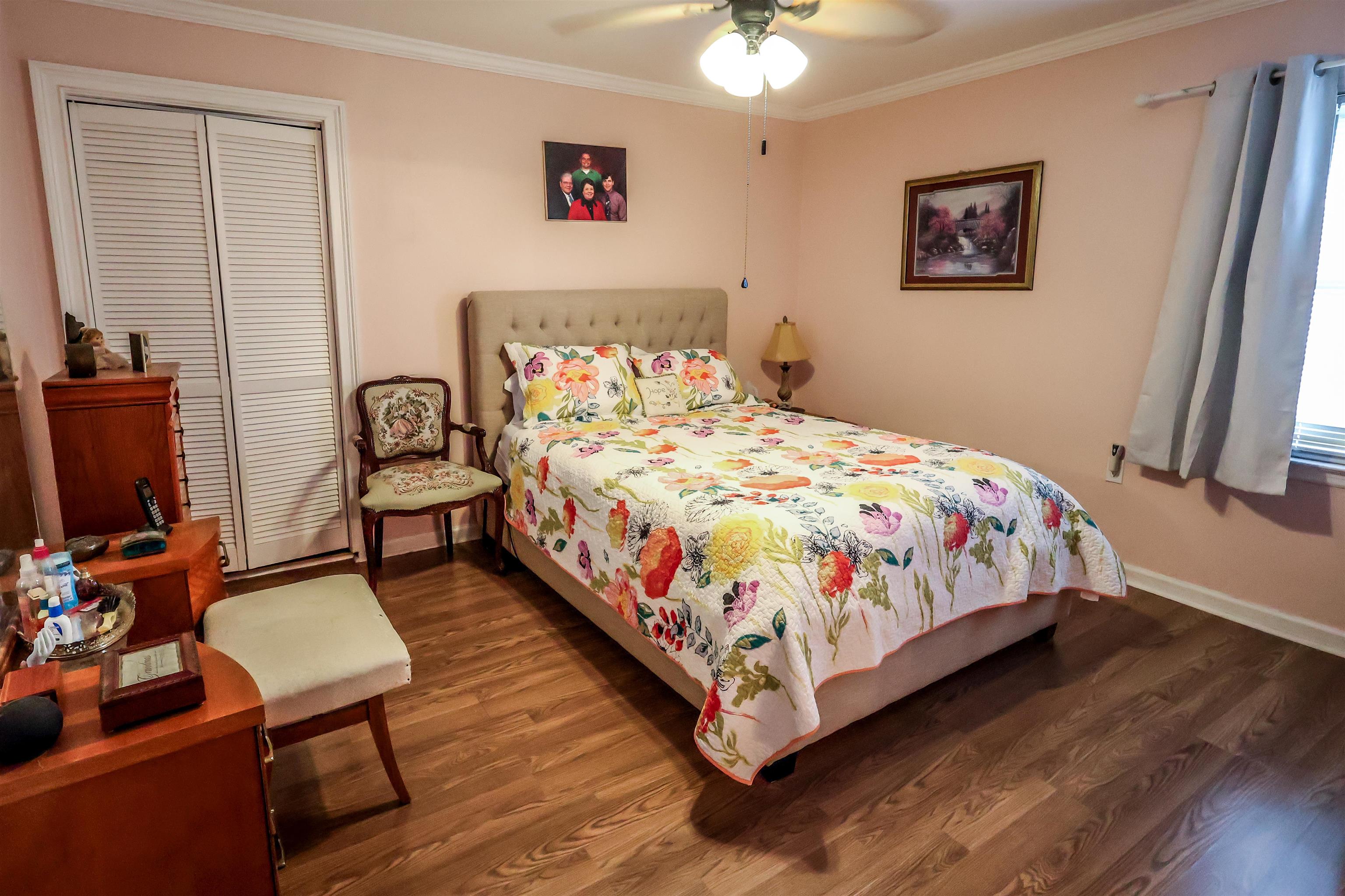 7840 Munford Giltedge Road Burlison, TN 38015 - Photo 22 of 38 Bedroom with dark wood-type flooring, ornamental molding, a ceiling fan, and a closet