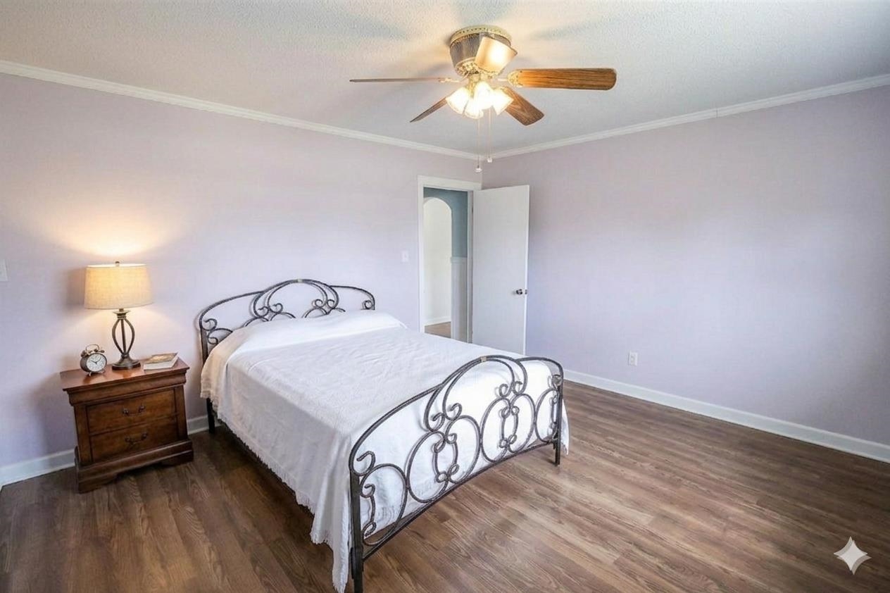 7840 Munford Giltedge Road Burlison, TN 38015 - Photo 27 of 38 a bedroom with a bed and a chandelier
