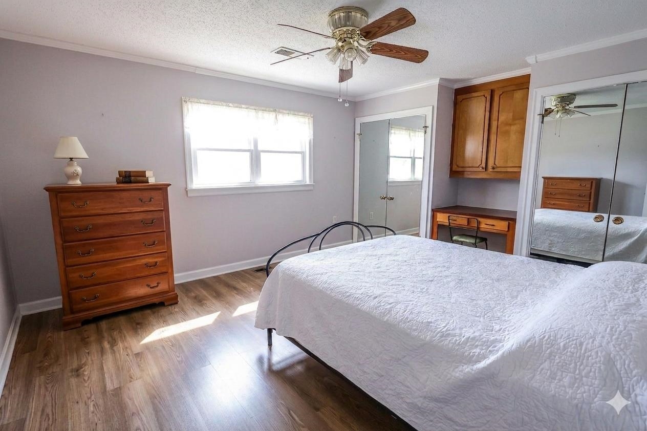 7840 Munford Giltedge Road Burlison, TN 38015 - Photo 29 of 38 a bedroom with a bed and wooden floor