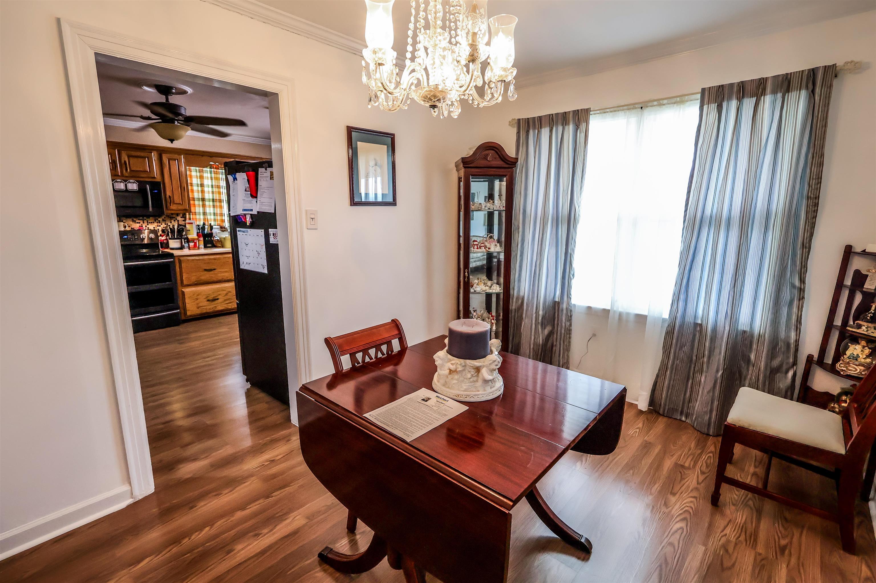 7840 Munford Giltedge Road Burlison, TN 38015 - Photo 32 of 38 a view of a dining room with furniture window and wooden floor