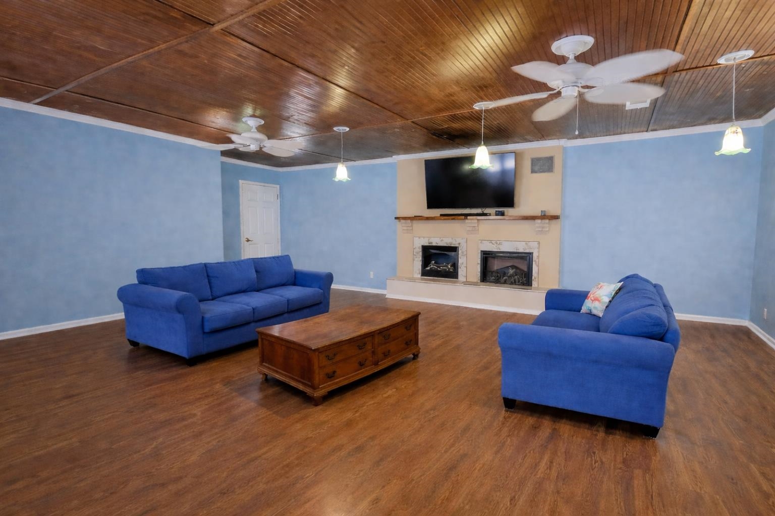 7840 Munford Giltedge Road Burlison, TN 38015 - Photo 8 of 38 Living area featuring wooden ceiling, dark wood-style flooring, a premium fireplace, ceiling fan, and crown molding. Photo is AI generated