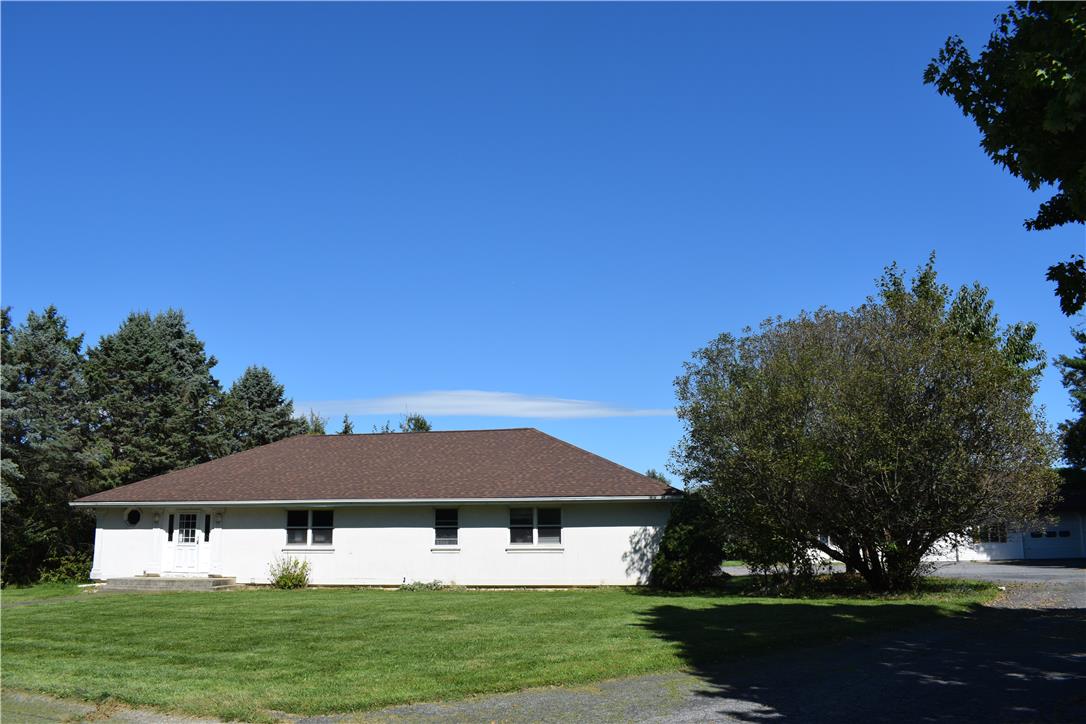 4035 Devonshire Road Bethlehem, PA 18020 - Photo 2 of 19 A spacious green lawn borders this ranch-style home set against a clear blue sky.