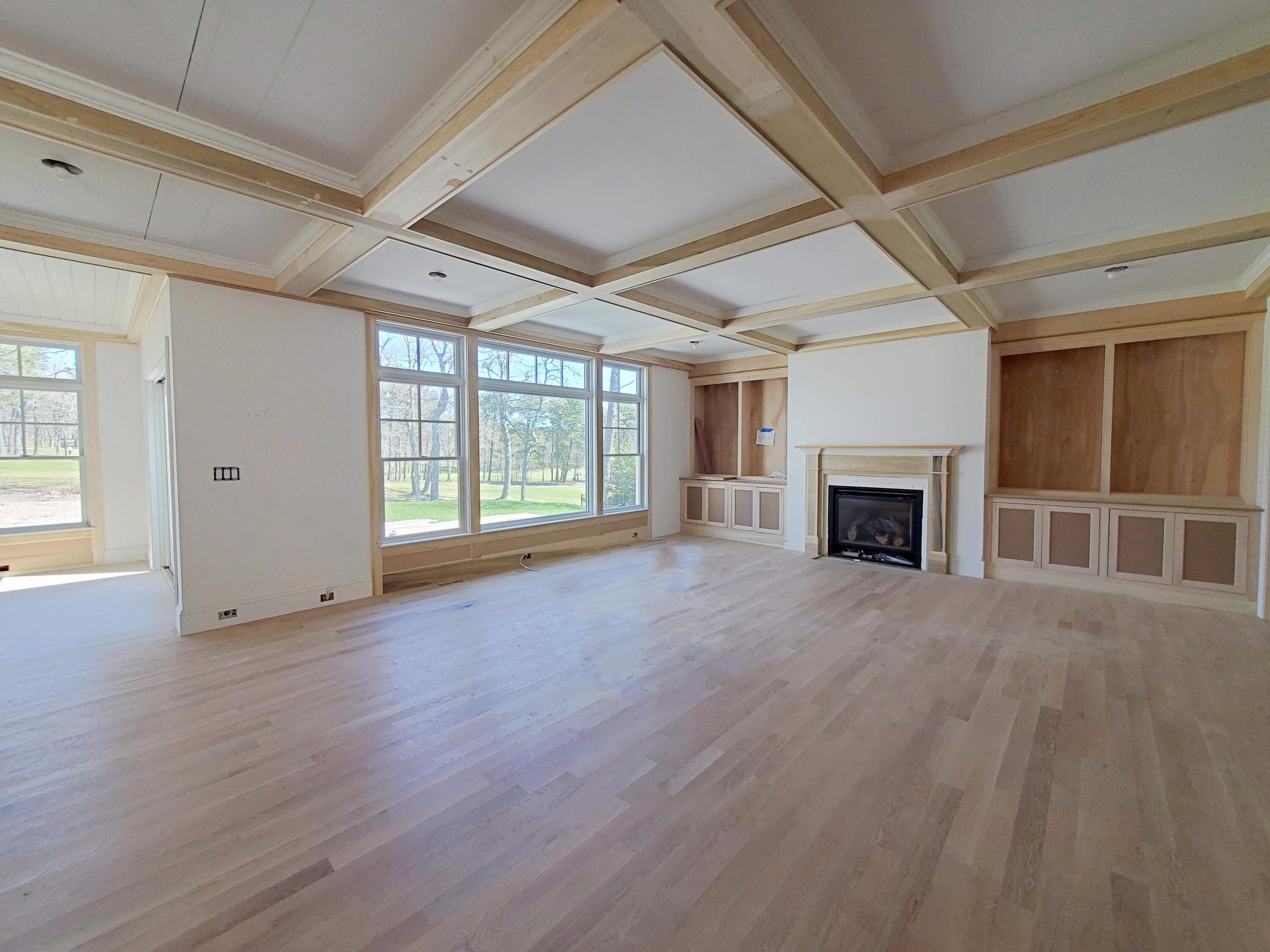 3 Snow Way Orleans, MA 02653 - Photo 16 of 33 an empty room with windows fireplace and wooden floor