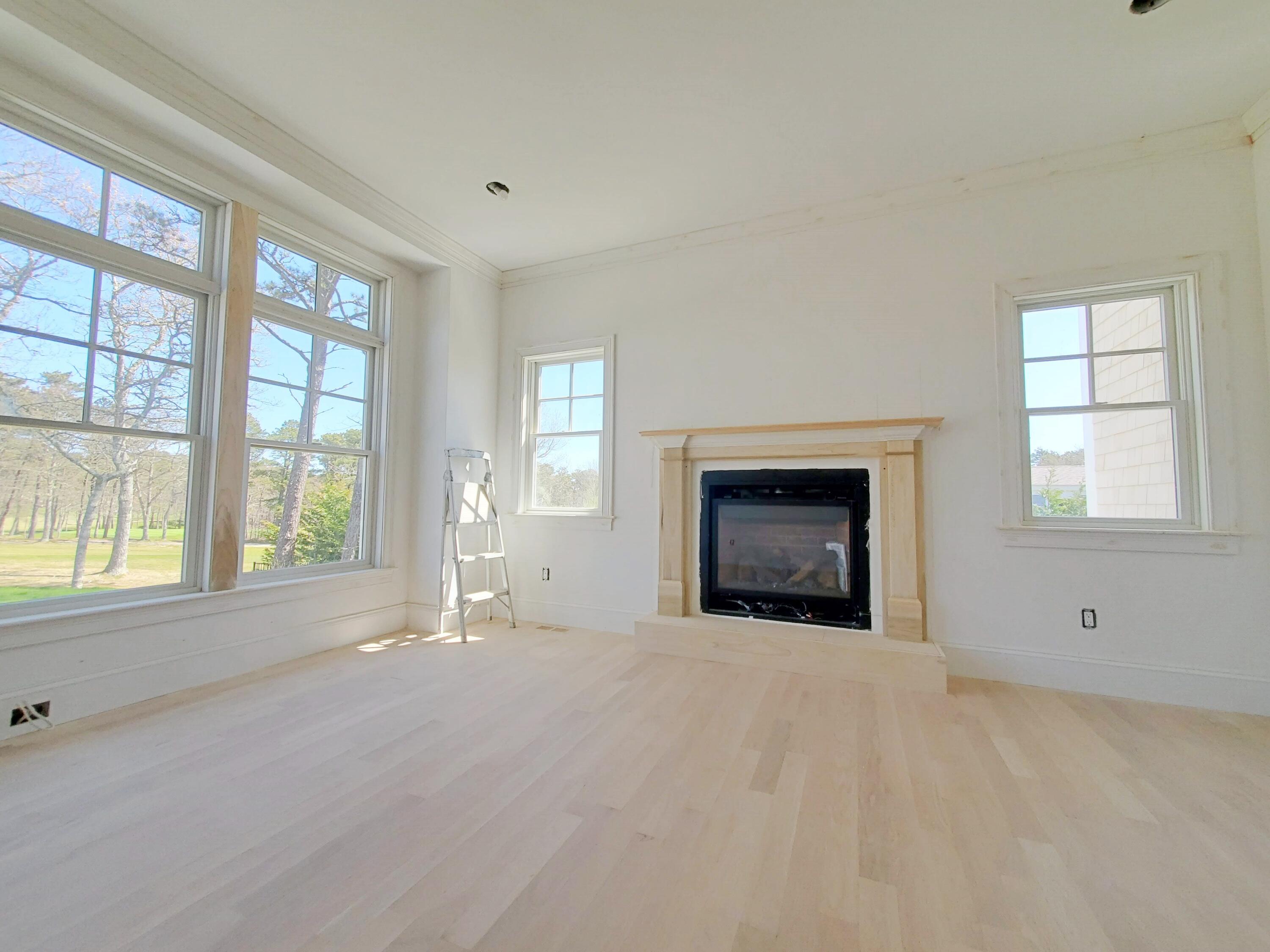 3 Snow Way Orleans, MA 02653 - Photo 19 of 33 a view of an empty room with a window and a fireplace