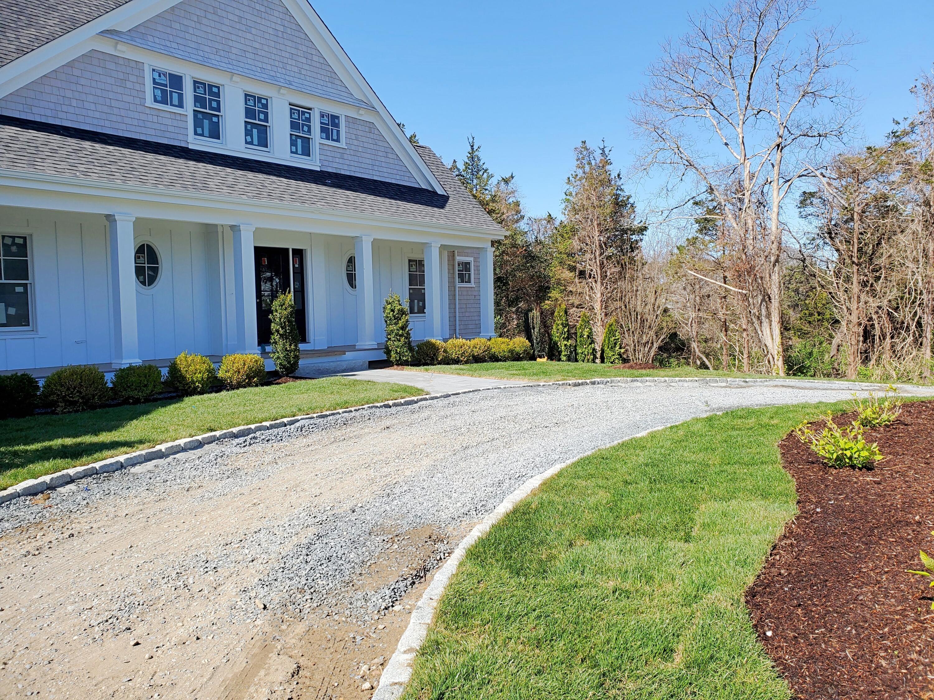 3 Snow Way Orleans, MA 02653 - Photo 2 of 33 a front view of a house with a yard and potted plants