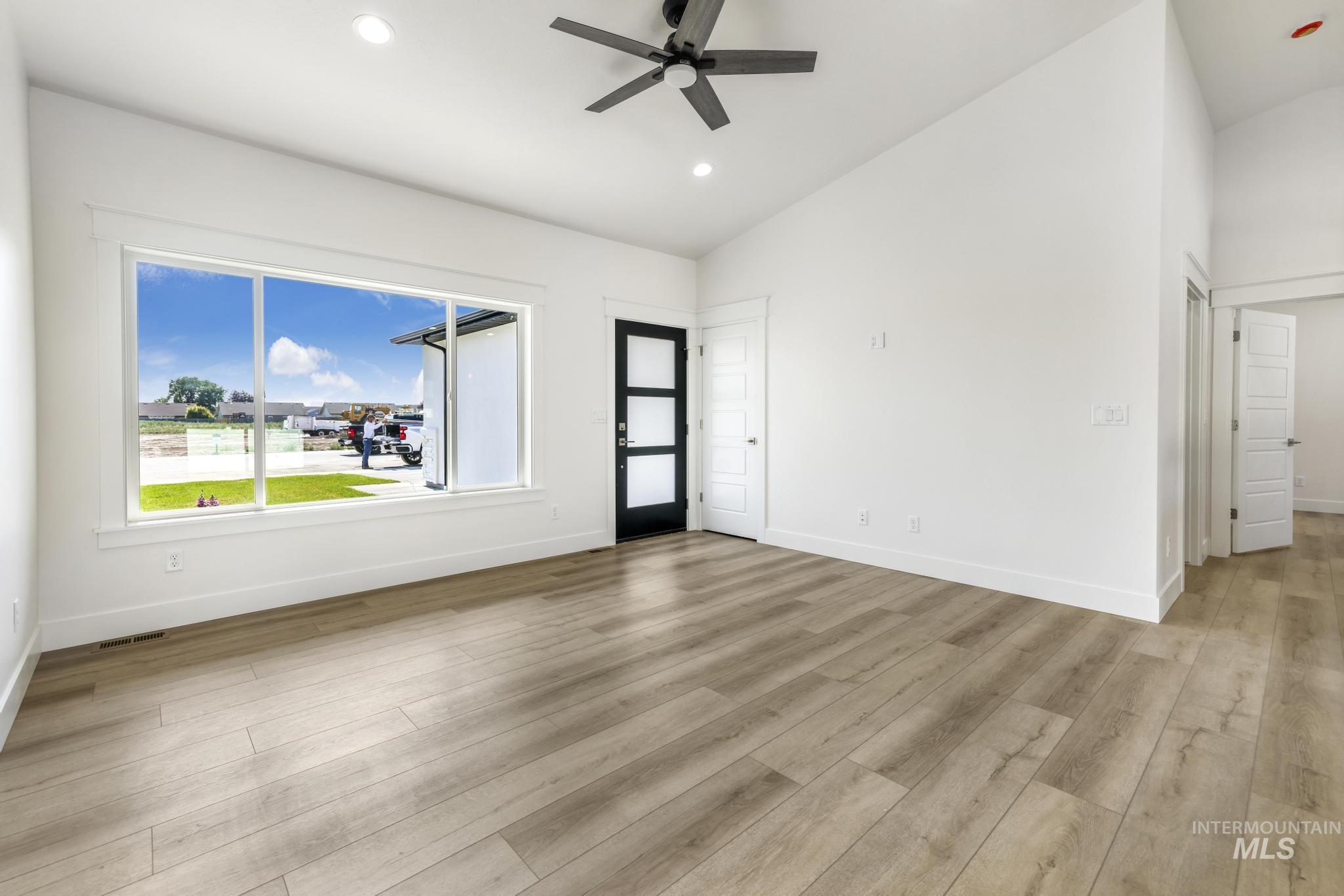 1428 Haizlee Way Twin Falls, ID 83301 - Photo 7 of 23 Unfurnished room featuring vaulted ceiling, ceiling fan, recessed lighting, and light wood-style floors