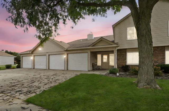 a front view of a house with a yard and pathway