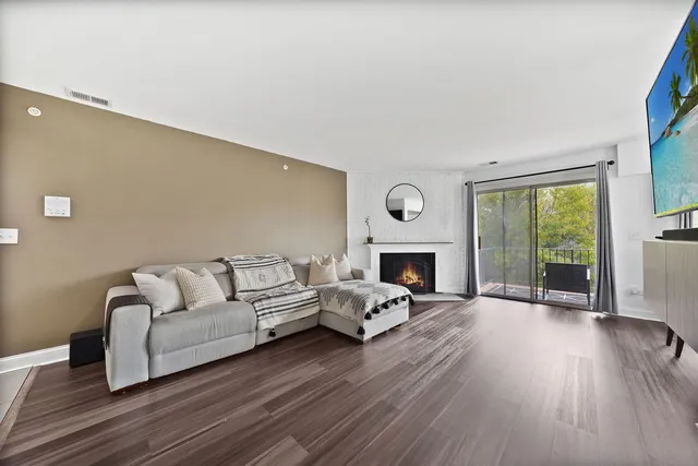 a living room with fireplace furniture and a wooden floor