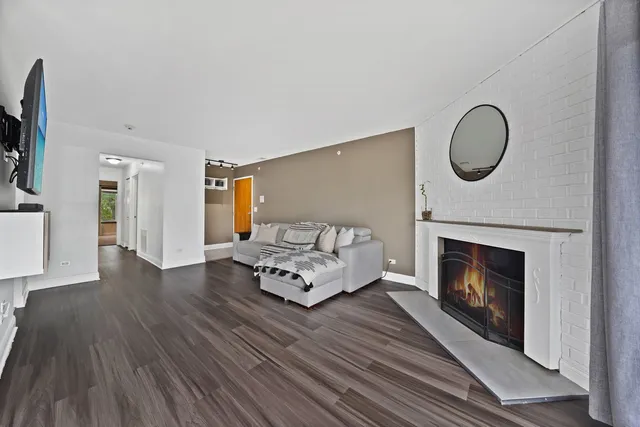 a living room with furniture mirror and fireplace