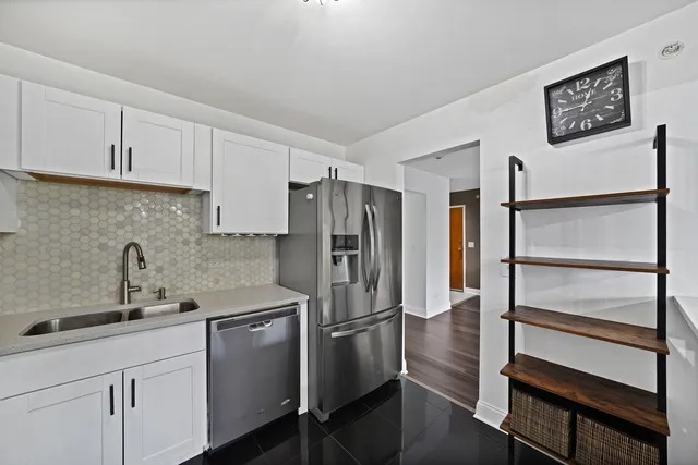 a kitchen with stainless steel appliances a refrigerator sink and cabinets