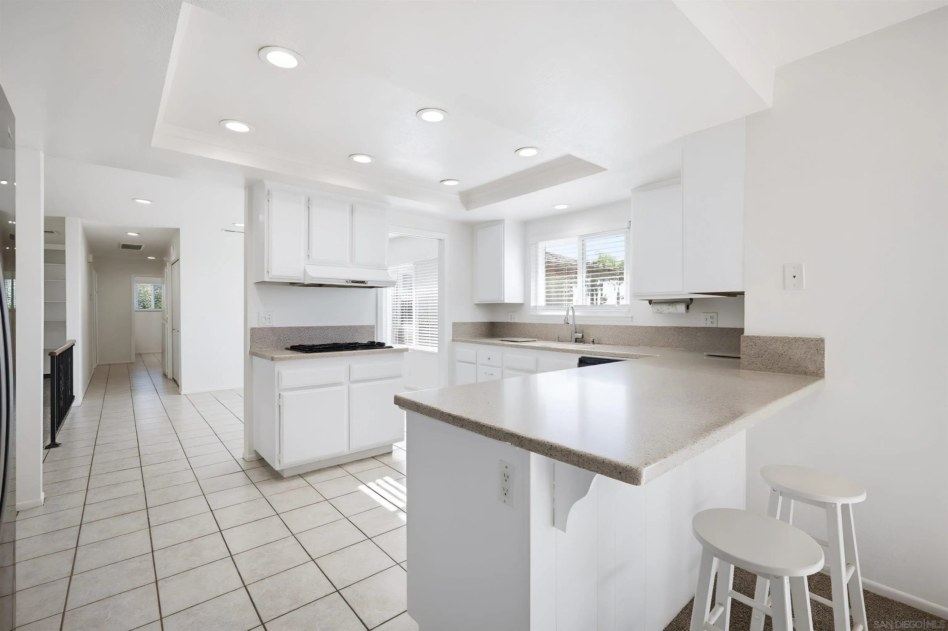 10365 Hidden Farm Road Rancho Cucamonga, CA 91737 - Photo 12 of 55 a kitchen with a sink a stove a refrigerator and white cabinets