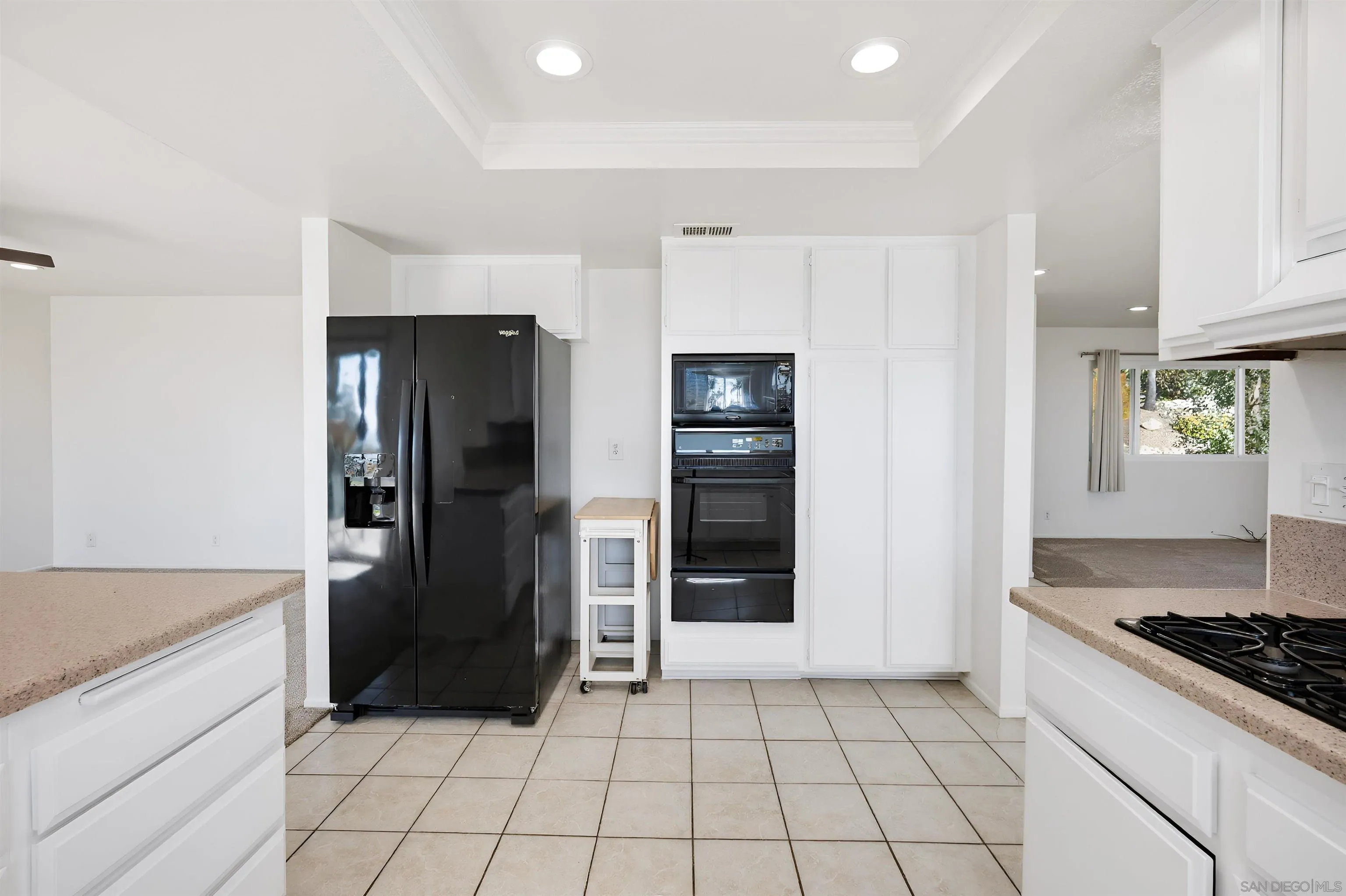 10365 Hidden Farm Road Rancho Cucamonga, CA 91737 - Photo 15 of 55 a kitchen with a refrigerator and a stove top oven