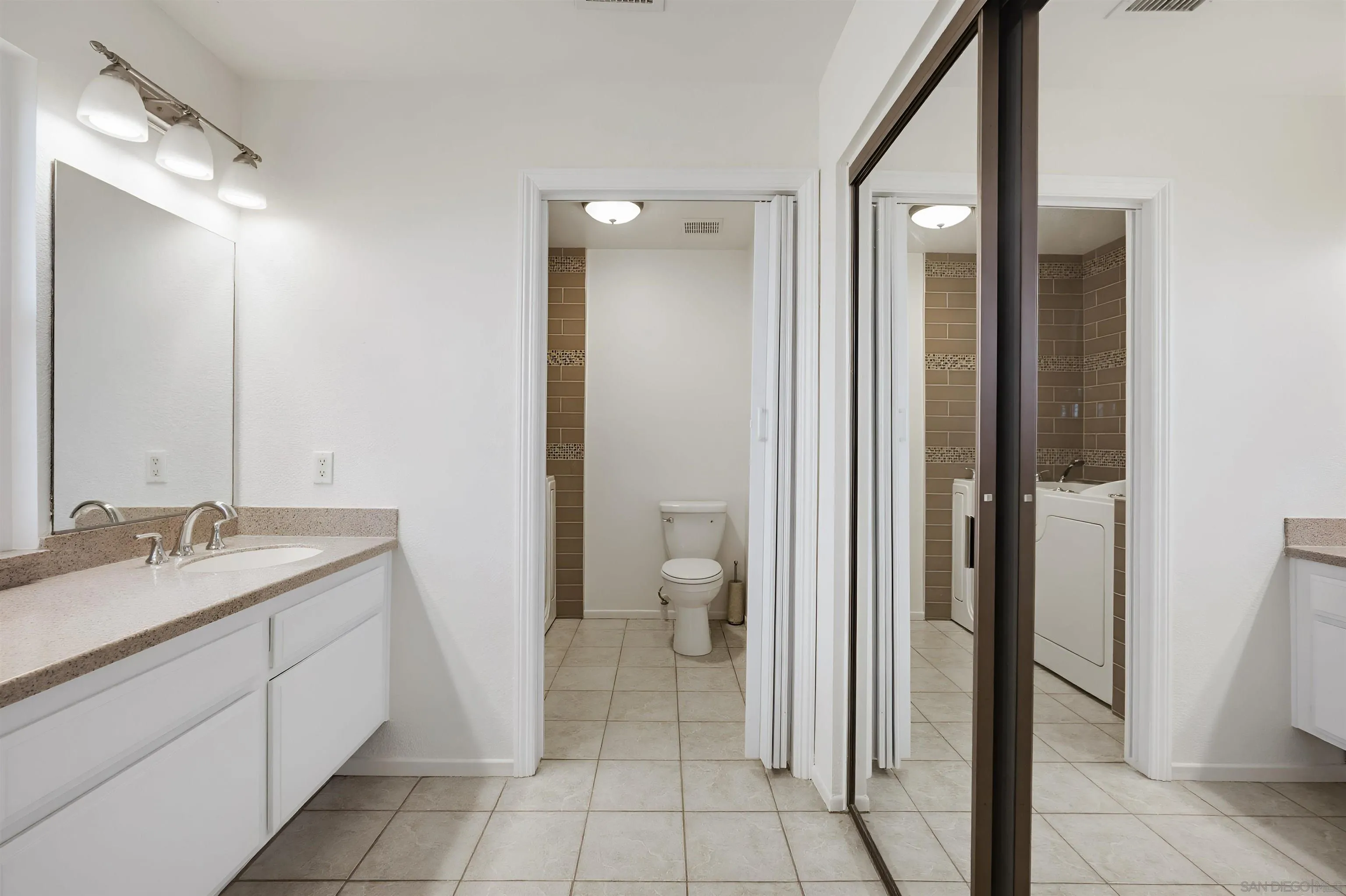 10365 Hidden Farm Road Rancho Cucamonga, CA 91737 - Photo 34 of 55 a spacious bathroom with a granite countertop sink mirror and a toilet