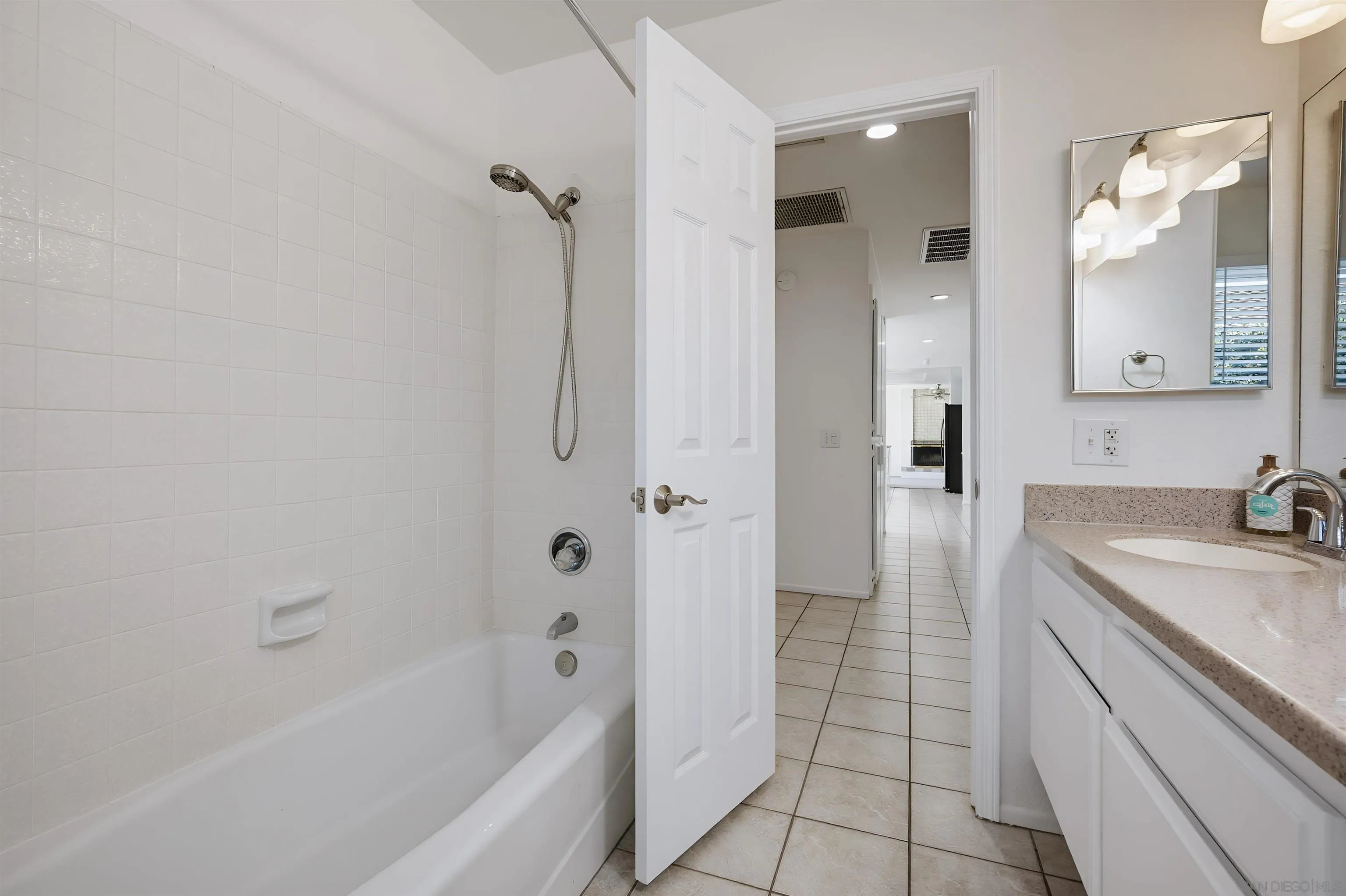 10365 Hidden Farm Road Rancho Cucamonga, CA 91737 - Photo 42 of 55 a bathroom with a sink a mirror and a bathtub