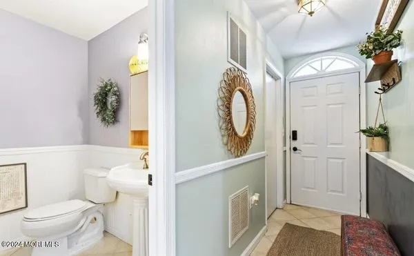 a bathroom with a toilet a sink and a mirror