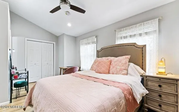 a bedroom with a bed and a window