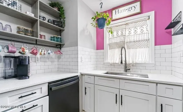 a kitchen with a sink cabinets and window