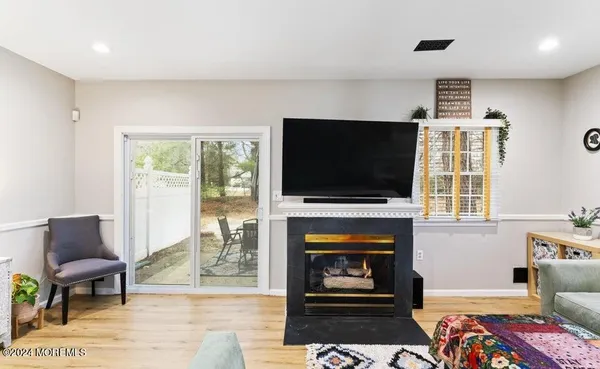 a living room with furniture fireplace and a flat screen tv