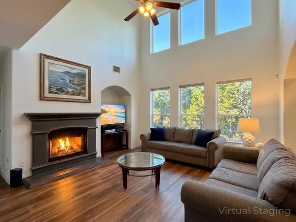 a living room with furniture and a fireplace