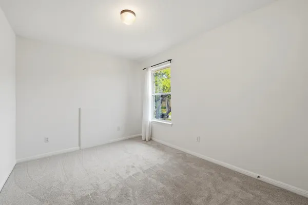 a bedroom with two beds and a window