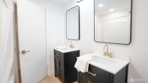 a bathroom with a sink vanity and a mirror