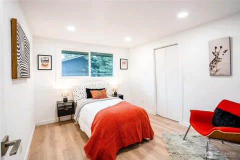 a bed room with a bed and a chair