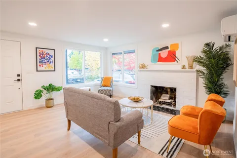 a living room with furniture potted plant and a fireplace