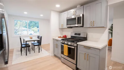 a kitchen with a stove a sink and a microwave