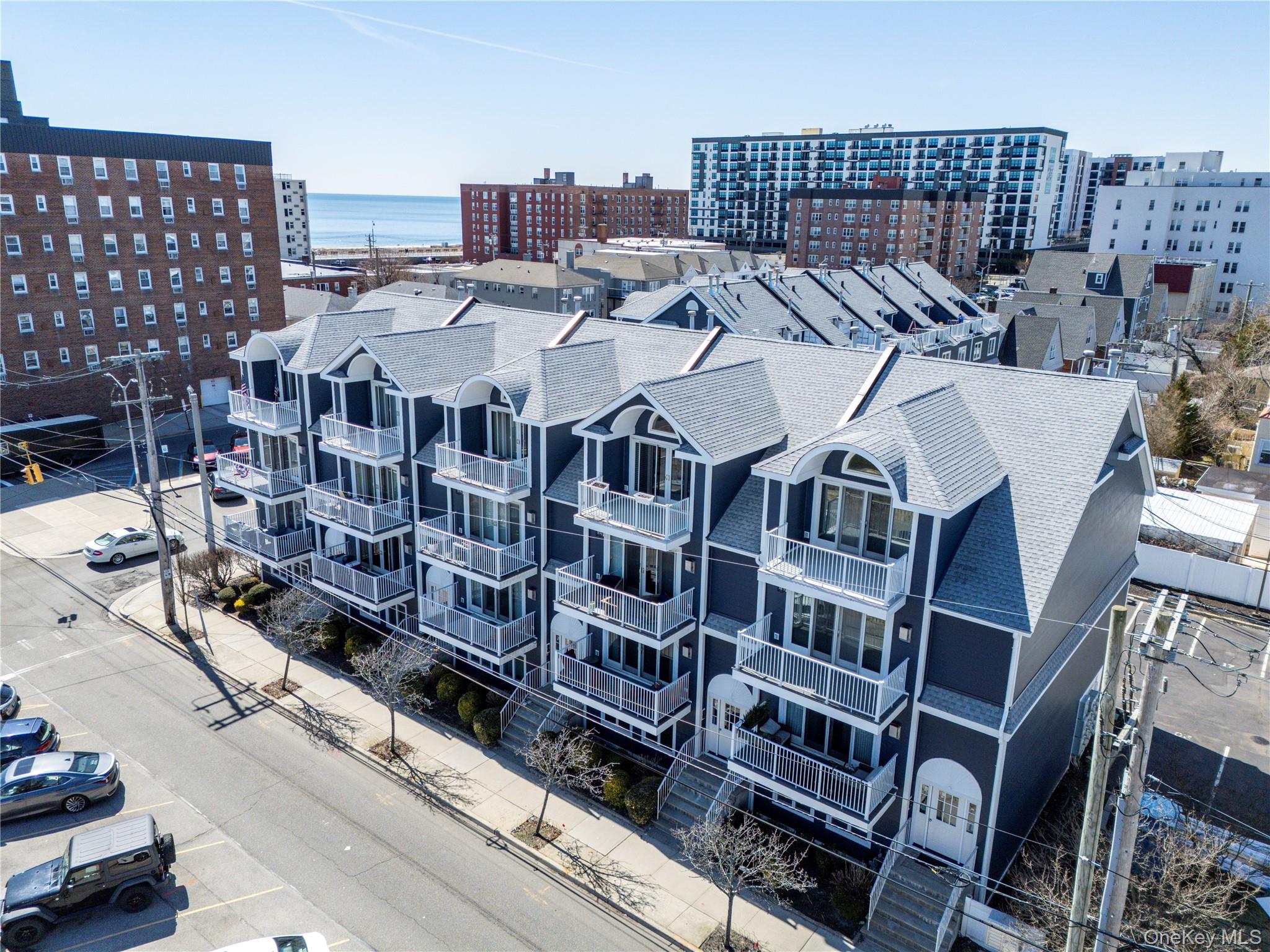 159 Monroe Boulevard, Unit UPPR Long Beach, NY 11561 - Photo 2 of 24 a view of a large building with a lot of windows