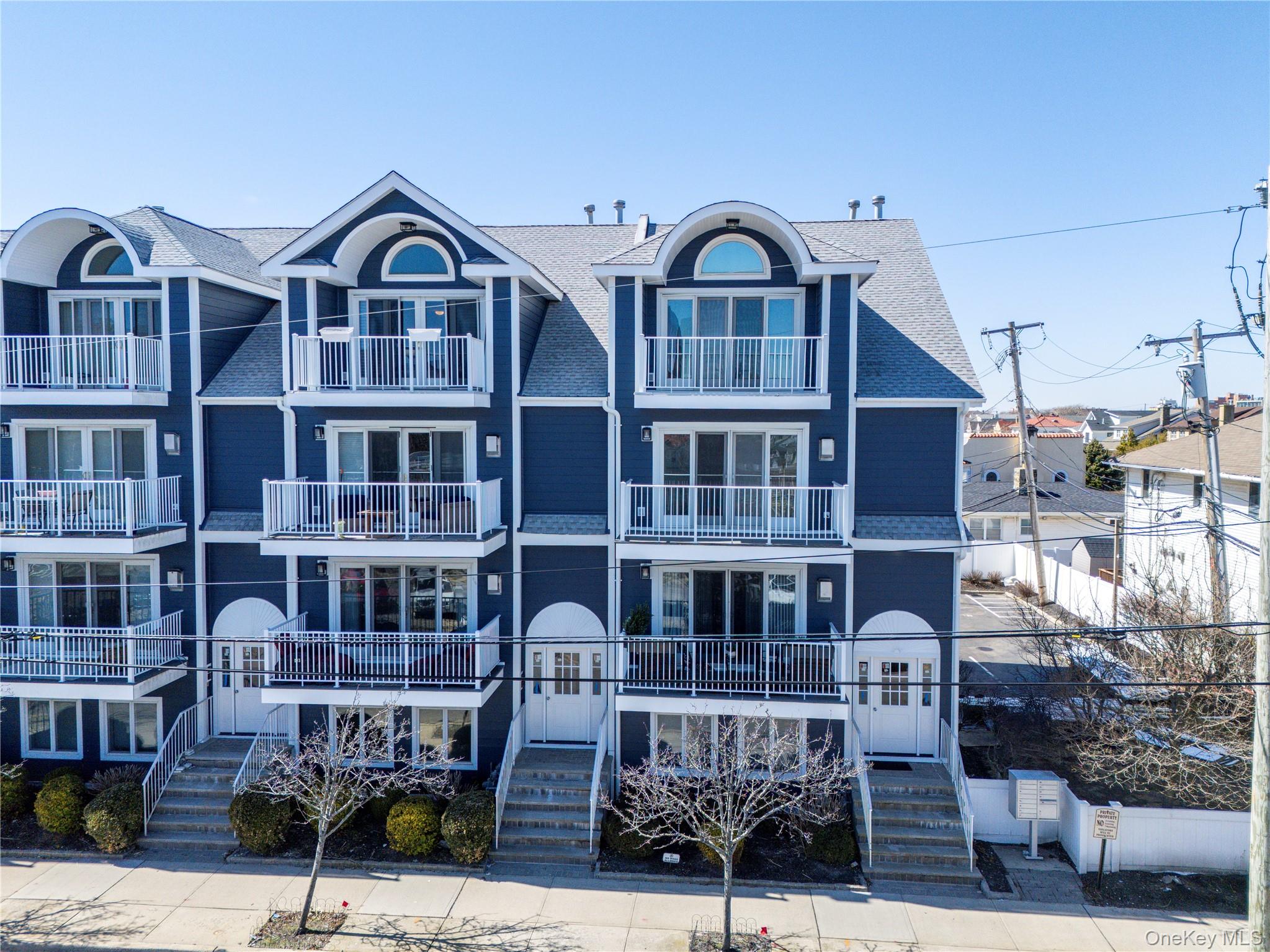 159 Monroe Boulevard, Unit UPPR Long Beach, NY 11561 - Photo 3 of 24 a front view of a building with balcony