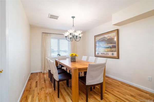 a view of a dining room with furniture and chandelier