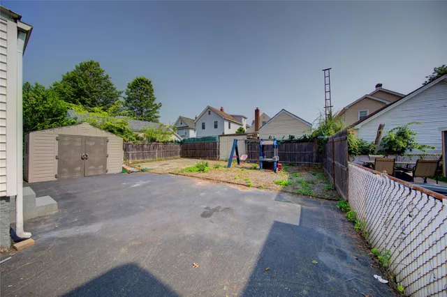 a view of a house with a yard and a garage