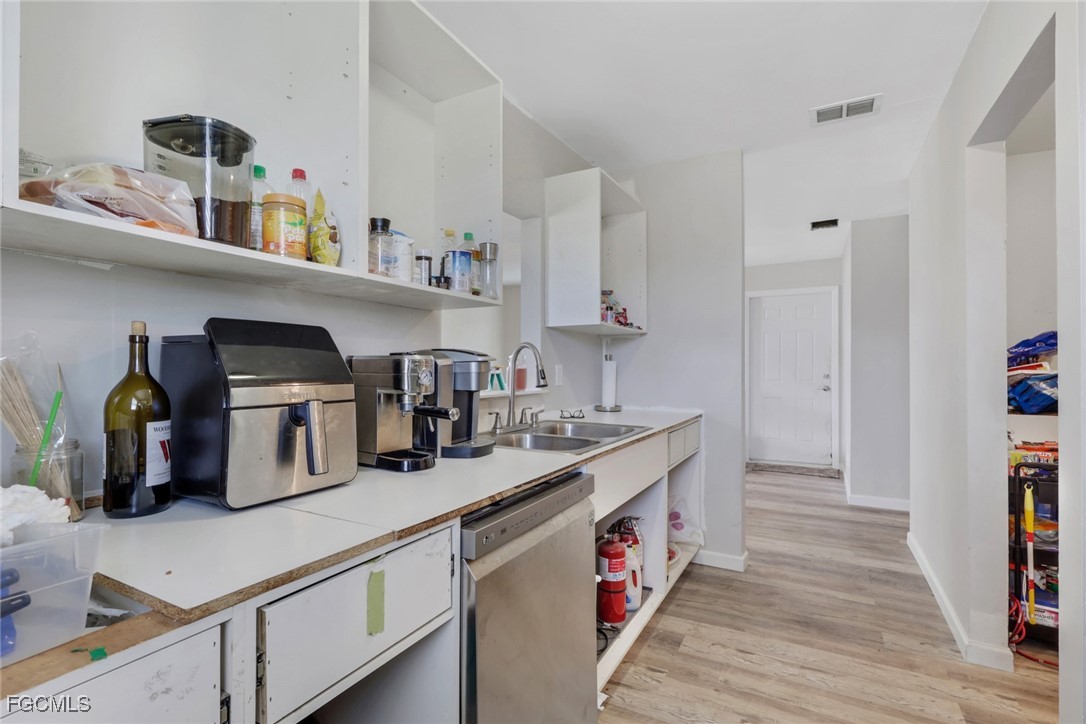 1506 Rena Avenue South Lehigh Acres, FL 33976 - Photo 13 of 39 a kitchen with refrigerator and cabinets