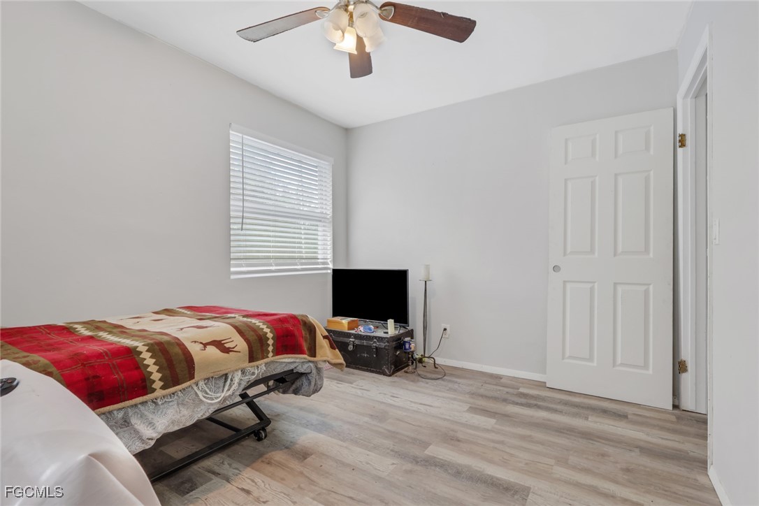 1506 Rena Avenue South Lehigh Acres, FL 33976 - Photo 16 of 39 a bedroom with a bed and flat screen tv