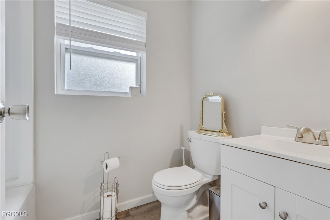 1506 Rena Avenue South Lehigh Acres, FL 33976 - Photo 17 of 39 a bathroom with a toilet sink and mirror