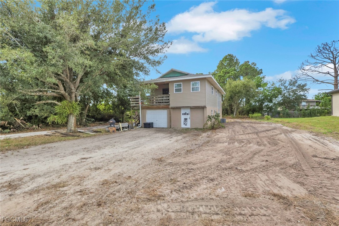 1506 Rena Avenue South Lehigh Acres, FL 33976 - Photo 2 of 39 a view of a house with a yard