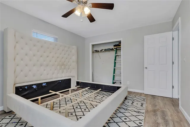 a view of a livingroom with wooden floor and a ceiling fan