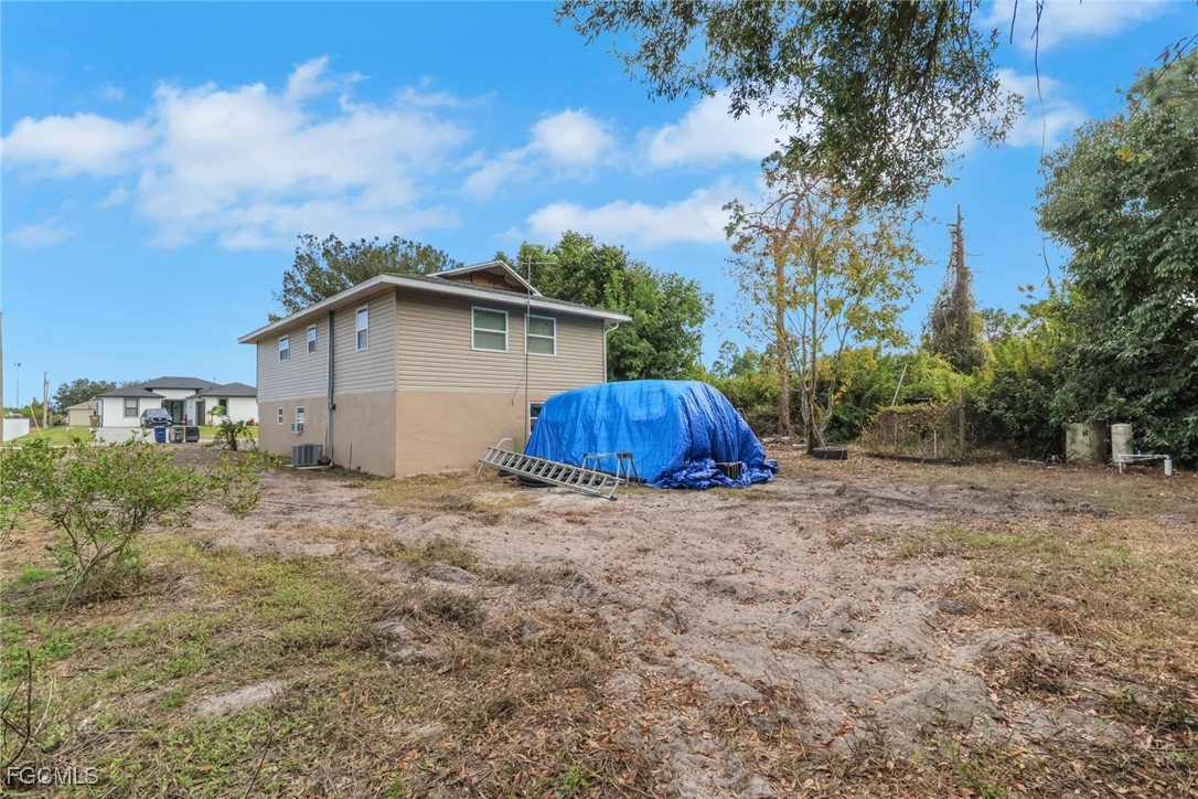 1506 Rena Avenue South Lehigh Acres, FL 33976 - Photo 23 of 39 a house with trees in the background