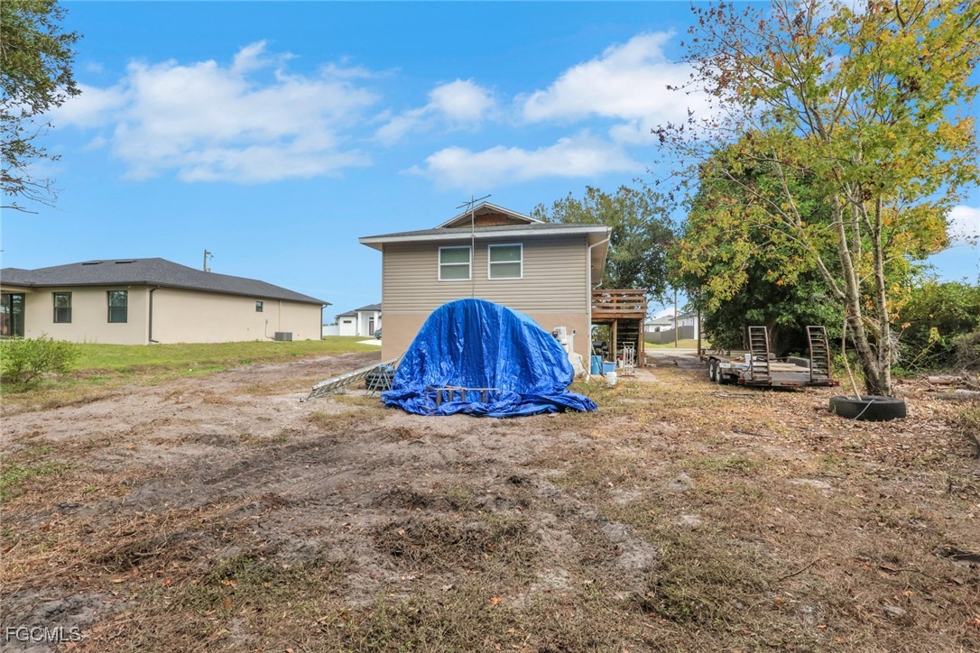 1506 Rena Avenue South Lehigh Acres, FL 33976 - Photo 24 of 39 a view of a house with a yard and garage