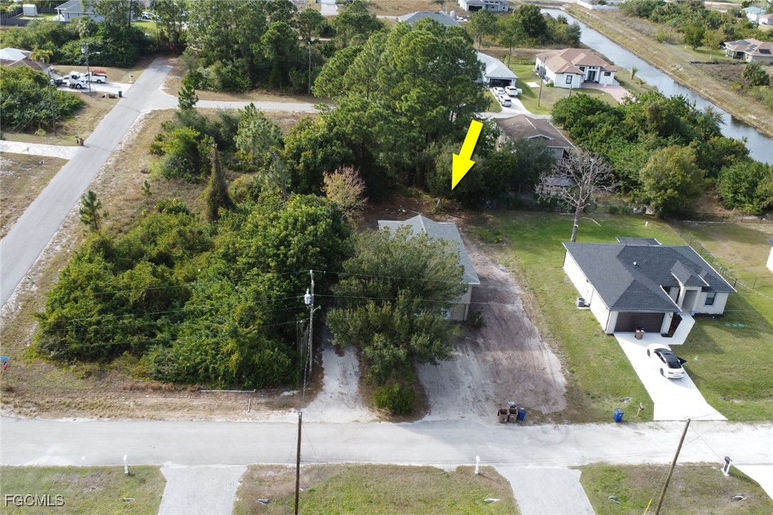1506 Rena Avenue South Lehigh Acres, FL 33976 - Photo 28 of 39 an aerial view of a house with outdoor space and a lake view